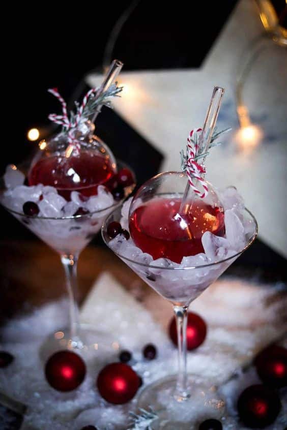 _ - 2025-12-05T100757521 - Celebrate in Style: Festive Ornament Cocktails for Holidays Festive red cocktails in martini glasses with ice and cranberries, decorated for the holidays.