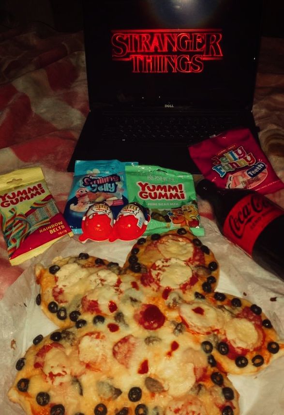 _ - 2025-12-05T105235332 - Demogorgon Pizza Recipe: Stranger Things Food Fun Snacks and pizza setup for a Stranger Things watch party with candy, gummy bears, and a Coca-Cola bottle.