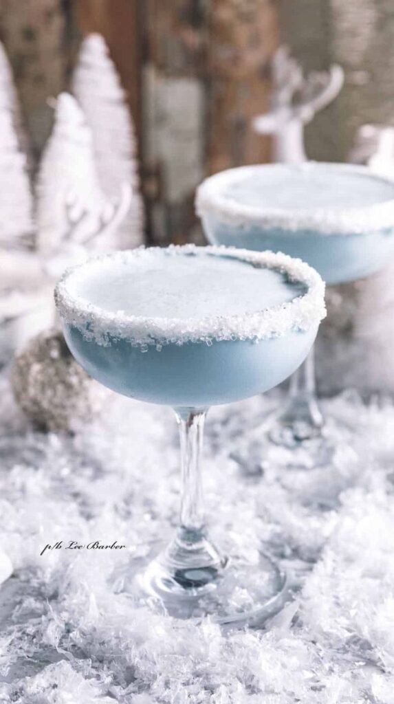 _ - 2025-12-16T155227918 - Blueberry Snow Martini: Cozy Winter Cocktail Recipe Frosty winter cocktail in a glass with sugar rim, set against a festive snowy background.