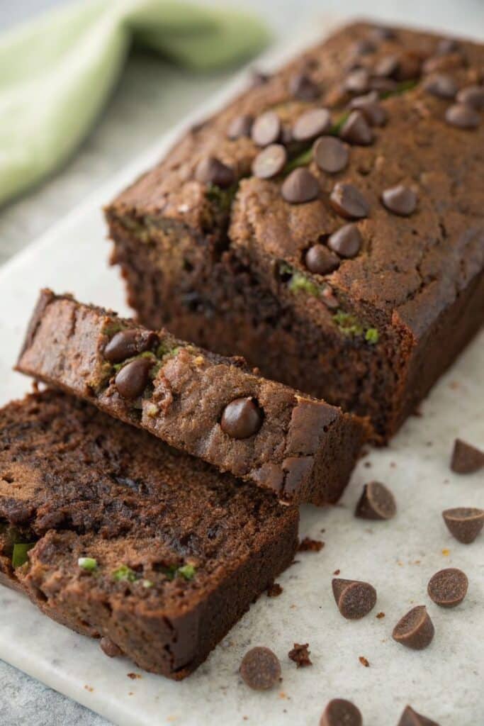 Chocolate Zucchini Bread Recipe - Versatile Zucchini Bread Recipe: Nutty, Chocolate, or Spiced Chocolate chip zucchini bread on a marble surface, sliced and ready to serve.