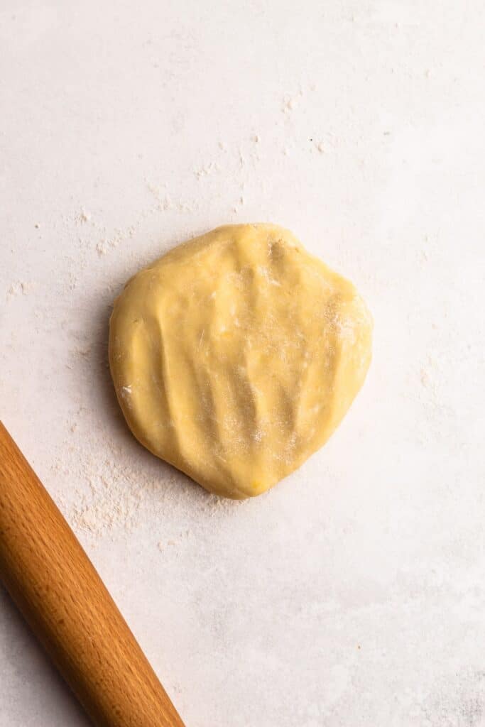 Classic-Custard-Pie-13 - Delicious Pistachio Pie Ideas for Parties and Holidays Ball of fresh dough on a floured surface beside a rolling pin, ready for baking.