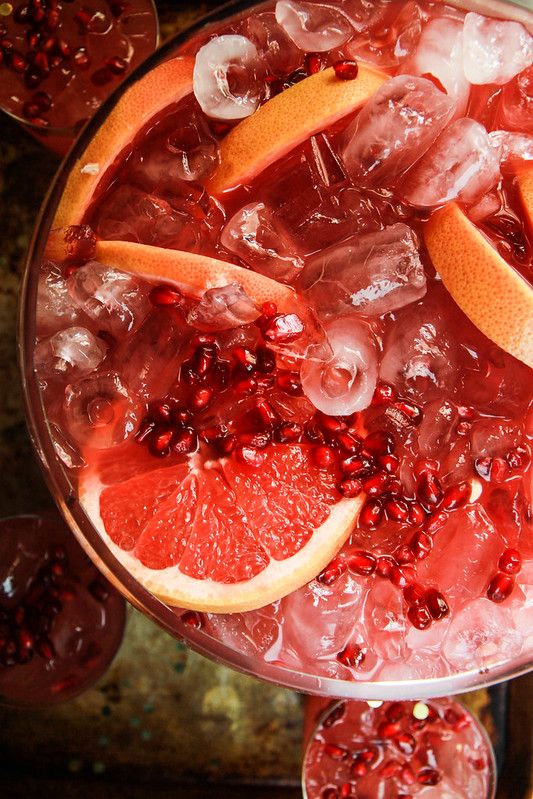 Pomegranate Ginger Paloma Punch - Heather Christo - Festive & Easy: Master the Perfect Pomegranate Paloma Refreshing grapefruit and pomegranate cocktail with ice, perfect for summer parties and gatherings.