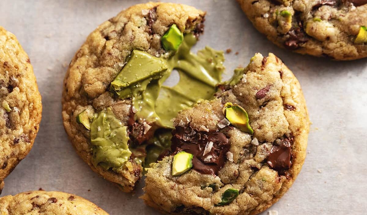Freshly baked pistachio chocolate cookies with a gooey center, perfect for a sweet and nutty treat.