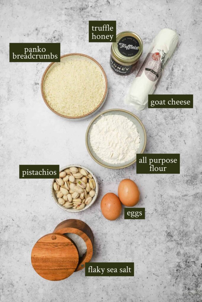 Ingredients-for-fried-goat-cheese-balls-scaled - Step-by-Step Guide to Perfect Fried Goat Cheese Balls Ingredients for a recipe: panko breadcrumbs, truffle honey, goat cheese, flour, pistachios, eggs, and flaky sea salt.