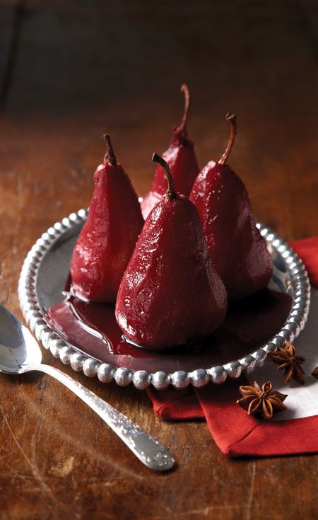 Poached Pears in Mulled Wine - Elegant Winter Dessert: Perfect Mulled Wine Poached Pears Poached pears in red wine on a silver plate with star anise garnish, perfect for a festive dessert setting.