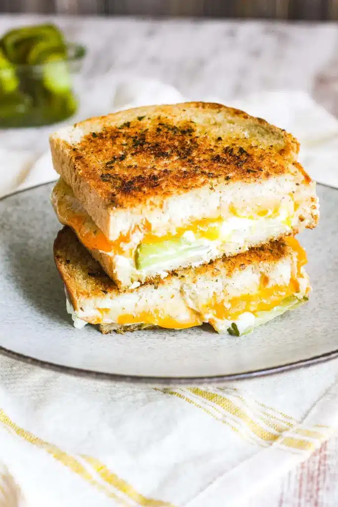 Grilled cheese sandwich with jalapeno and melted cheese on a plate. Perfect lunch idea for spice lovers.